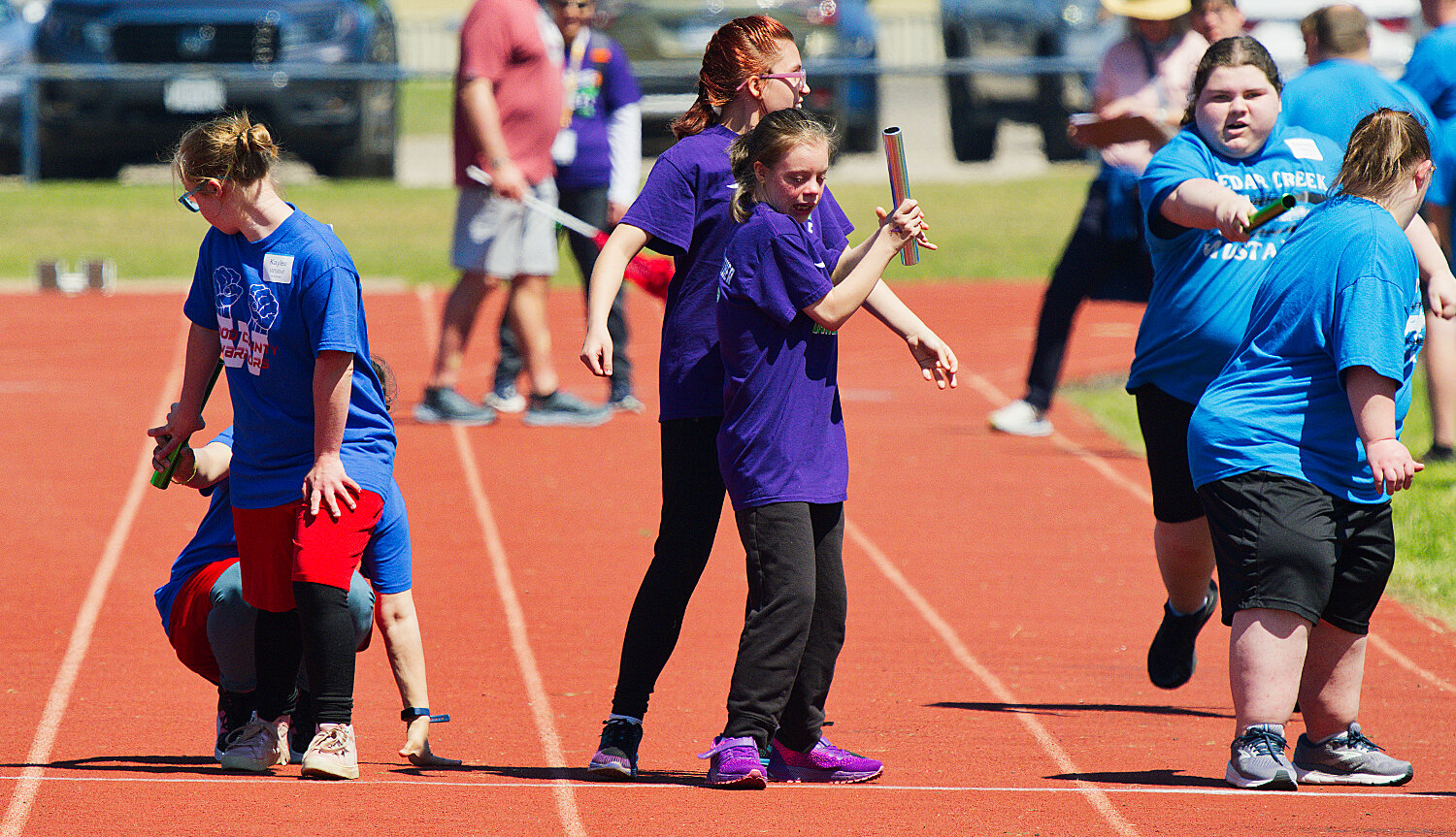 All three relay teams successfully execute their baton handoffs to their last leg. [see more special olympics success]